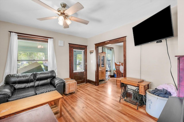 138 N Elm St, Paxton, IL 60957 - living area with light wood finished floors, healthy amount of natural light, and a ceiling fan