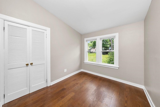 23951 N Lakeside Dr, Lake Zurich, IL 60047 - unfurnished bedroom featuring vaulted ceiling, dark wood-style flooring, and a closet