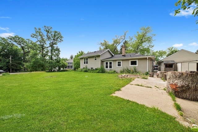 23951 N Lakeside Dr, Lake Zurich, IL 60047 - back of house with a lawn and a chimney
