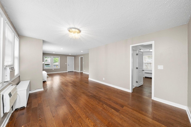 23951 N Lakeside Dr, Lake Zurich, IL 60047 - unfurnished living room with radiator heating unit, wood finished floors, a textured ceiling, and a chandelier