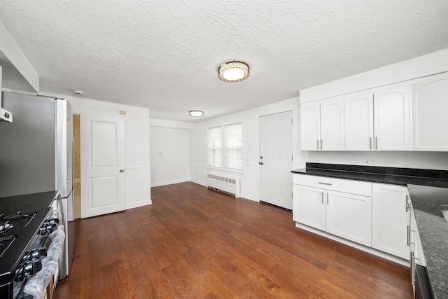 23951 N Lakeside Dr, Lake Zurich, IL 60047 - kitchen with radiator heating unit, range, dark wood finished floors, white cabinetry, and a textured ceiling