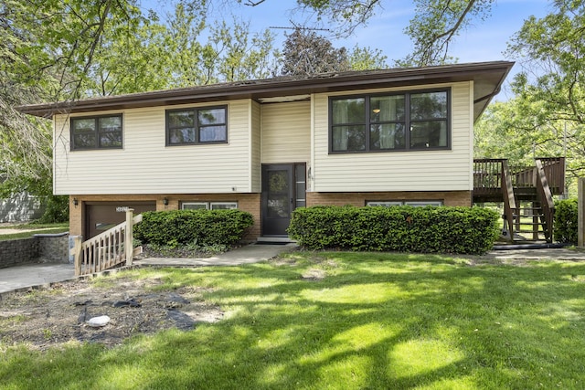 26W331 Geneva Rd, Wheaton, IL 60187 - split foyer home featuring stairway, brick siding, a garage, a front lawn, and a wooden deck