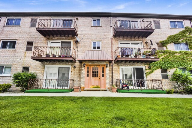 5739 W 63rd St Unit 3S, Chicago, IL 60638 - rear view of house featuring a lawn, brick siding, and a balcony