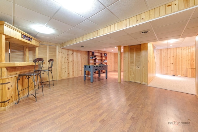 325 Pearl St, Cary, IL 60013 - playroom featuring a drop ceiling, wood finished floors, wooden walls, and baseboards