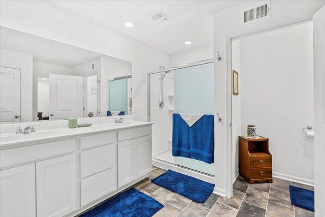 6904 Spruce Ct, Wonder Lake, IL 60097 - full bathroom featuring a shower stall, double vanity, and baseboards