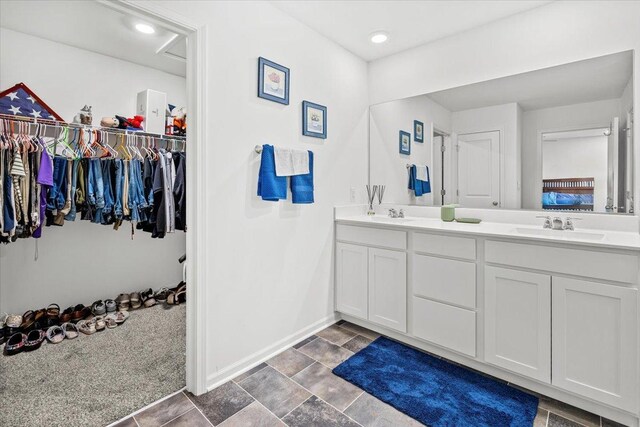 6904 Spruce Ct, Wonder Lake, IL 60097 - full bathroom with double vanity, baseboards, and a spacious closet