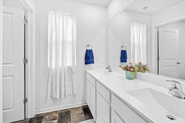 6904 Spruce Ct, Wonder Lake, IL 60097 - full bath with double vanity, stone finish floors, and baseboards
