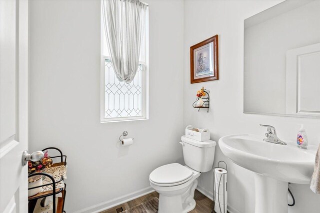 6904 Spruce Ct, Wonder Lake, IL 60097 - bathroom featuring toilet, baseboards, and wood finished floors