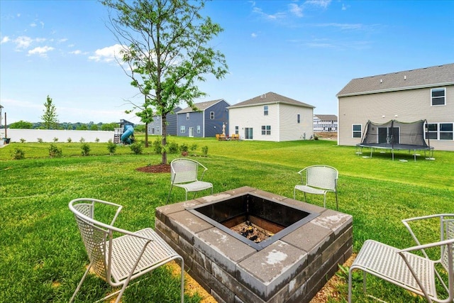 6904 Spruce Ct, Wonder Lake, IL 60097 - view of green lawn featuring a fire pit, a trampoline, and a water view