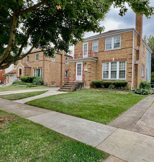 9214 S Sacramento Ave, Evergreen Park, IL 60805 - view of front of home with a front yard, brick siding, and a chimney