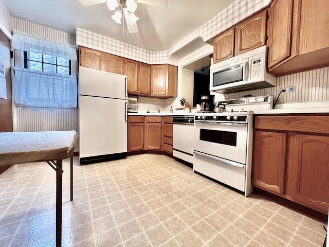 9214 S Sacramento Ave, Evergreen Park, IL 60805 - kitchen featuring white appliances, light flooring, light countertops, ceiling fan, and brown cabinets