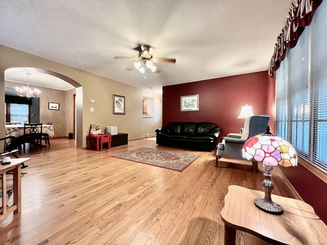 9214 S Sacramento Ave, Evergreen Park, IL 60805 - living room with arched walkways, ceiling fan, wood finished floors, and a chandelier