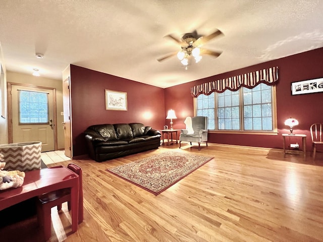 9214 S Sacramento Ave, Evergreen Park, IL 60805 - living area with light wood-style flooring, a textured ceiling, a ceiling fan, and plenty of natural light