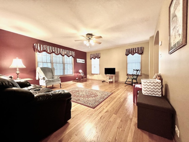 9214 S Sacramento Ave, Evergreen Park, IL 60805 - living room with wood finished floors, healthy amount of natural light, ceiling fan, and arched walkways