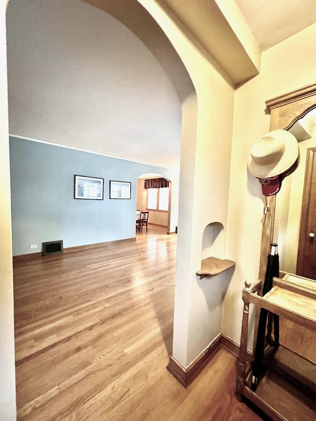 9214 S Sacramento Ave, Evergreen Park, IL 60805 - corridor with arched walkways, wood finished floors, and baseboards