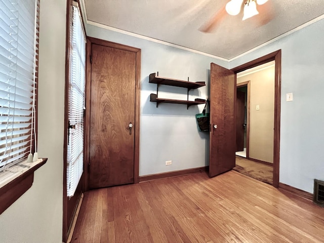 9214 S Sacramento Ave, Evergreen Park, IL 60805 - unfurnished bedroom with light wood-style floors, baseboards, and crown molding