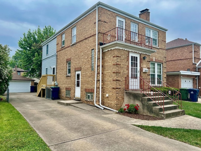 9214 S Sacramento Ave, Evergreen Park, IL 60805 - view of front facade with brick siding, a chimney, an outbuilding, and a detached garage