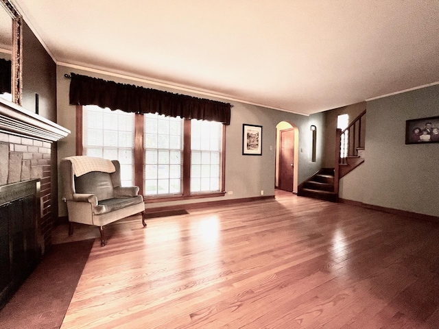 9214 S Sacramento Ave, Evergreen Park, IL 60805 - unfurnished living room with arched walkways, ornamental molding, light wood-type flooring, a fireplace, and stairway