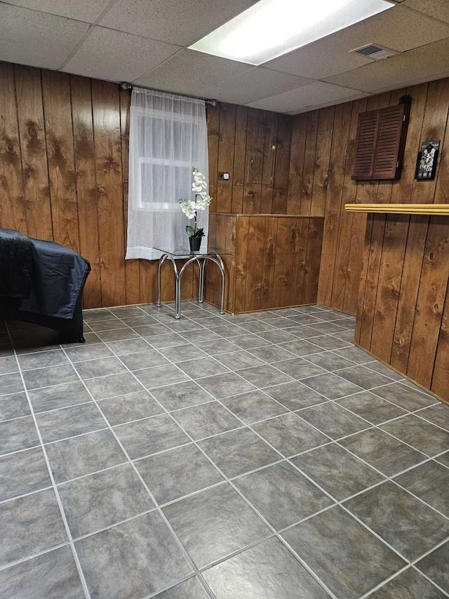 441 Commanche Trl, Wheeling, IL 60090 - finished basement featuring a drop ceiling, tile patterned flooring, and wood walls