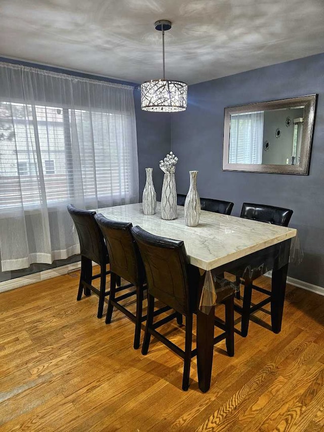 441 Commanche Trl, Wheeling, IL 60090 - dining space featuring wood finished floors, healthy amount of natural light, and a chandelier