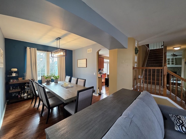3331 Banford Cir, Lake In The Hills, IL 60156 - dining space with stairway, dark wood finished floors, a chandelier, and arched walkways