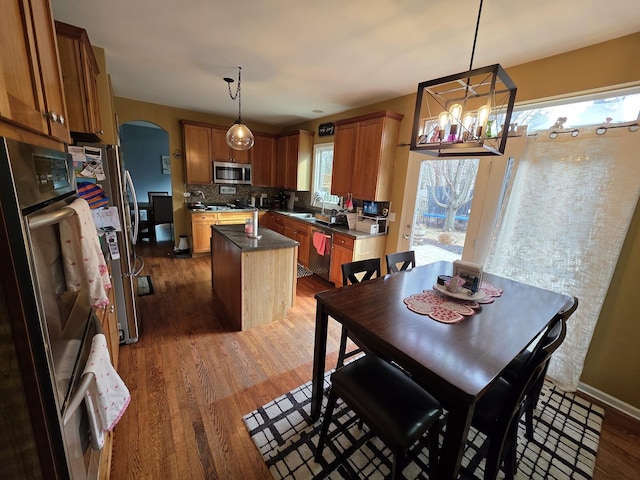 3331 Banford Cir, Lake In The Hills, IL 60156 - dining room featuring arched walkways, wood finished floors, a chandelier, and baseboards