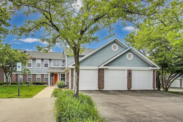 215 W Jennifer Ln Unit 1, Palatine, IL 60067 - view of front of home featuring brick siding, asphalt driveway, and an attached garage