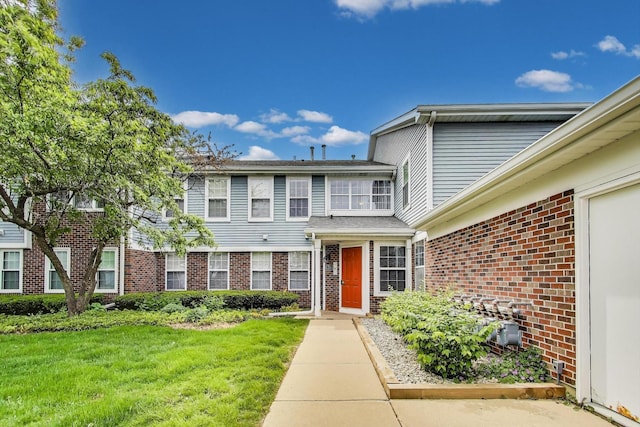 215 W Jennifer Ln Unit 1, Palatine, IL 60067 - view of property with brick siding and a front yard