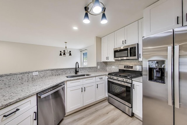 215 W Jennifer Ln Unit 1, Palatine, IL 60067 - kitchen featuring appliances with stainless steel finishes, a sink, white cabinetry, and light wood-style flooring