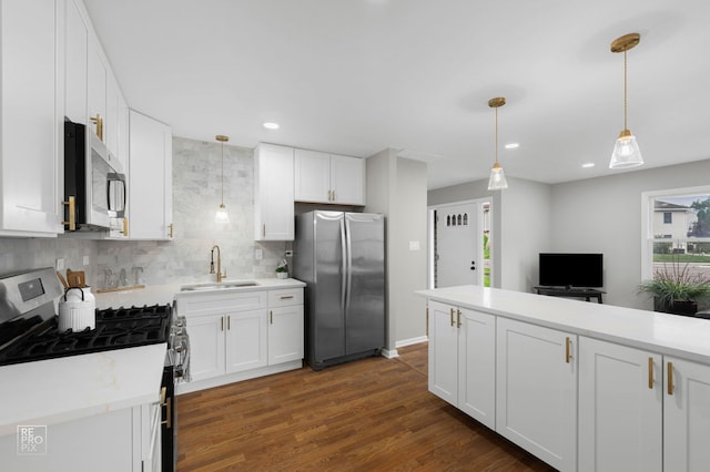 401 Monet Cir, Bolingbrook, IL 60440 - kitchen featuring appliances with stainless steel finishes, a sink, light countertops, tasteful backsplash, and white cabinetry