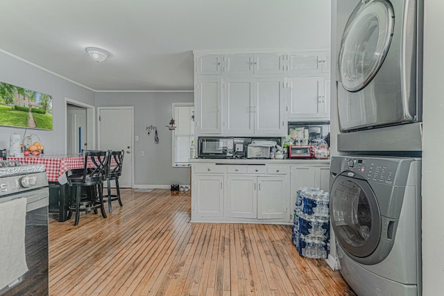 552 Walnut Ave, Elgin, IL 60123 - laundry room featuring estacked washer and dryer, light wood finished floors, ornamental molding, and baseboards