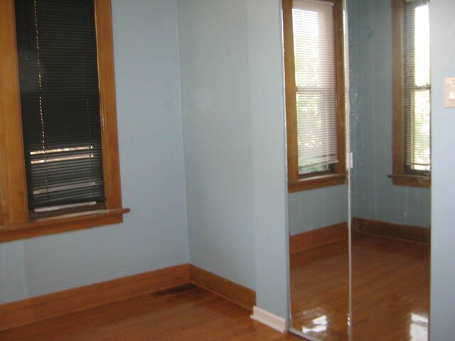 2339 N Kilbourn Ave, Chicago, IL 60639 - unfurnished room with wood finished floors and baseboards