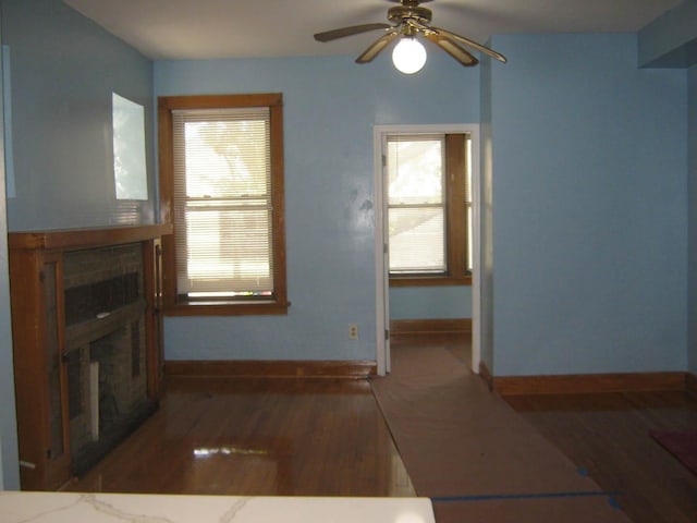 2339 N Kilbourn Ave, Chicago, IL 60639 - unfurnished living room with a fireplace, wood finished floors, plenty of natural light, and ceiling fan
