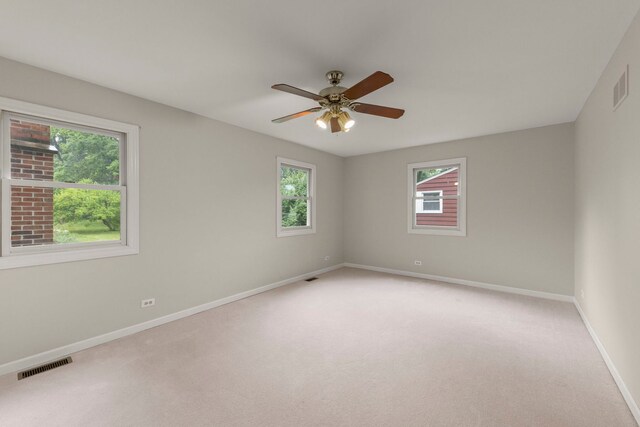 27W268 Hoy Ave, Warrenville, IL 60555 - spare room featuring healthy amount of natural light, baseboards, a ceiling fan, and light carpet