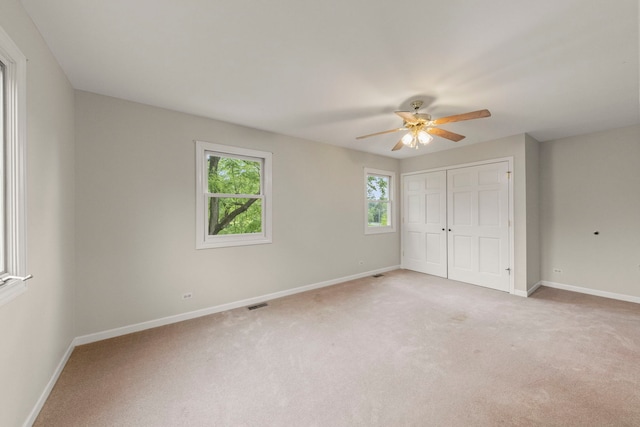 27W268 Hoy Ave, Warrenville, IL 60555 - unfurnished bedroom featuring baseboards, light colored carpet, a closet, and ceiling fan