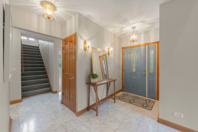 27W268 Hoy Ave, Warrenville, IL 60555 - foyer entrance with baseboards, light marble finish flooring, stairs, and a chandelier