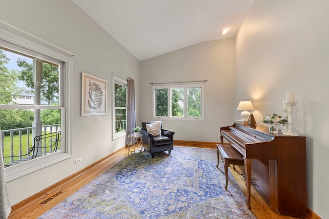 27W268 Hoy Ave, Warrenville, IL 60555 - living area with lofted ceiling, wood finished floors, and baseboards