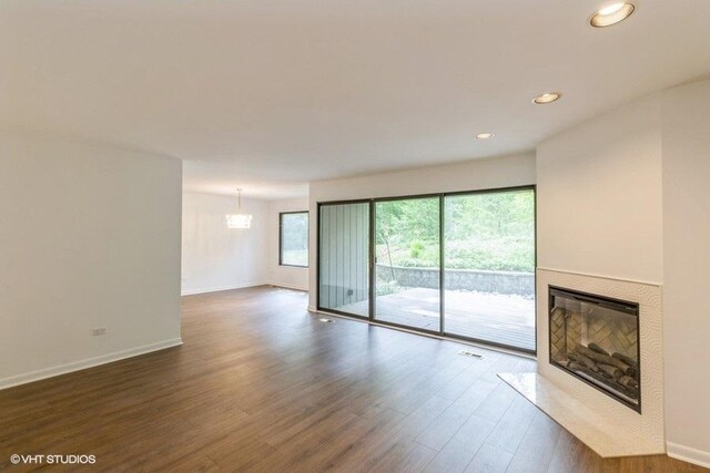 729 Old Barn Rd Unit C, Lake Barrington, IL 60010 - unfurnished living room featuring a glass covered fireplace, dark wood-style flooring, and recessed lighting