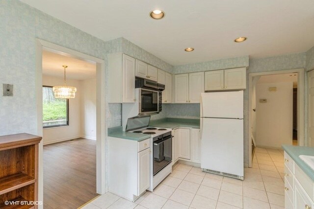 729 Old Barn Rd Unit C, Lake Barrington, IL 60010 - kitchen featuring white appliances, light countertops, decorative backsplash, a chandelier, and white cabinetry
