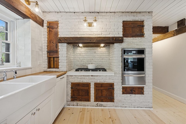 3622 Fairview Ave, Downers Grove, IL 60515 - kitchen featuring a warming drawer, stainless steel appliances, wooden ceiling, light wood-style flooring, and white cabinetry