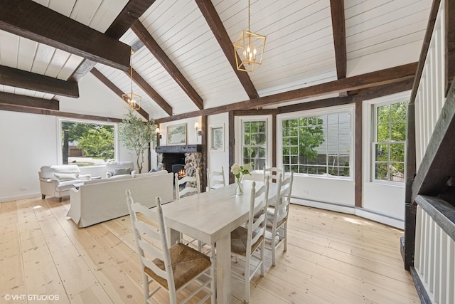 3622 Fairview Ave, Downers Grove, IL 60515 - dining space with a baseboard radiator, a chandelier, a fireplace, and plenty of natural light