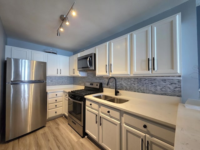 6700 S S Shore Dr Unit 18K, Chicago, IL 60649 - kitchen with appliances with stainless steel finishes, a sink, light countertops, light wood-type flooring, and white cabinetry