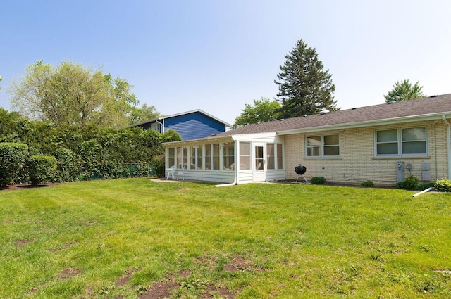 1128 N King Charles Ct, Palatine, IL 60067 - rear view of house with a lawn, a sunroom, and brick siding