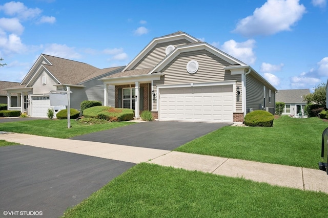 3332 Sheridan Ln, Mundelein, IL 60060 - view of front of property with asphalt driveway, a garage, a front yard, and brick siding