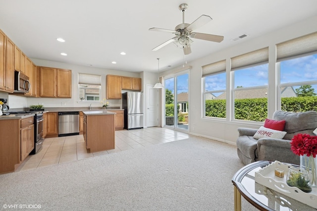 3332 Sheridan Ln, Mundelein, IL 60060 - kitchen with appliances with stainless steel finishes, open floor plan, recessed lighting, light tile patterned flooring, and a center island