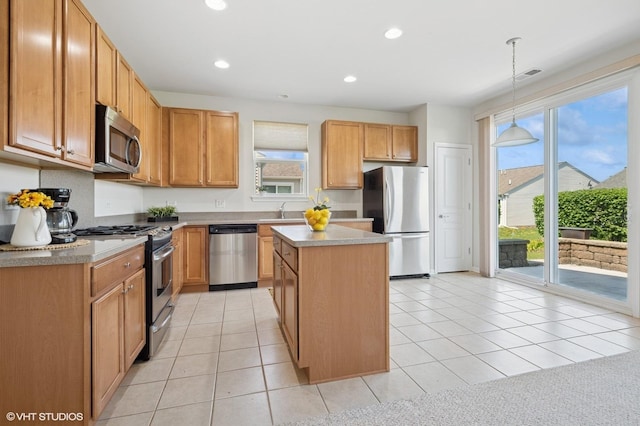3332 Sheridan Ln, Mundelein, IL 60060 - kitchen featuring stainless steel appliances, a kitchen island, healthy amount of natural light, recessed lighting, and light countertops