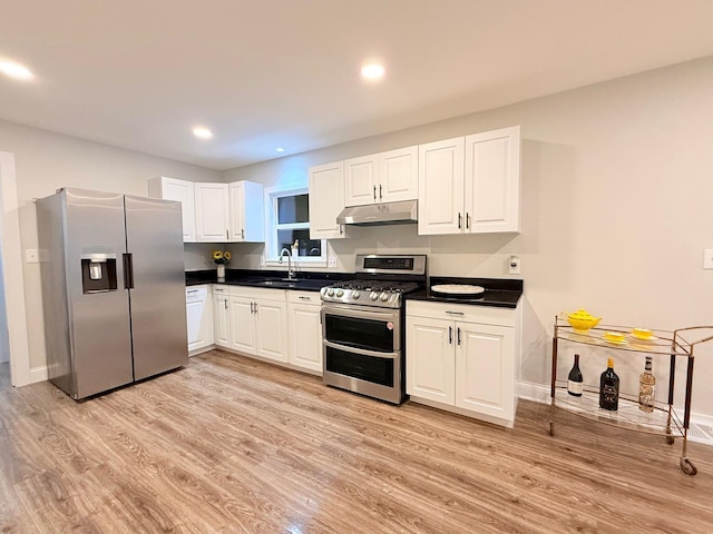 1327 N Pleasant Dr, Round Lake Beach, IL 60073 - kitchen featuring stainless steel appliances, under cabinet range hood, dark countertops, light wood finished floors, and recessed lighting