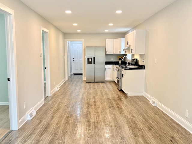 1327 N Pleasant Dr, Round Lake Beach, IL 60073 - kitchen with appliances with stainless steel finishes, light wood-style flooring, white cabinets, recessed lighting, and baseboards