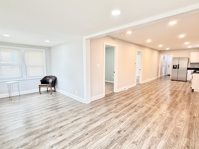 1327 N Pleasant Dr, Round Lake Beach, IL 60073 - unfurnished living room with light wood-style floors, baseboards, and recessed lighting