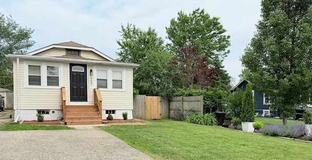 1327 N Pleasant Dr, Round Lake Beach, IL 60073 - view of front facade with entry steps and a gate